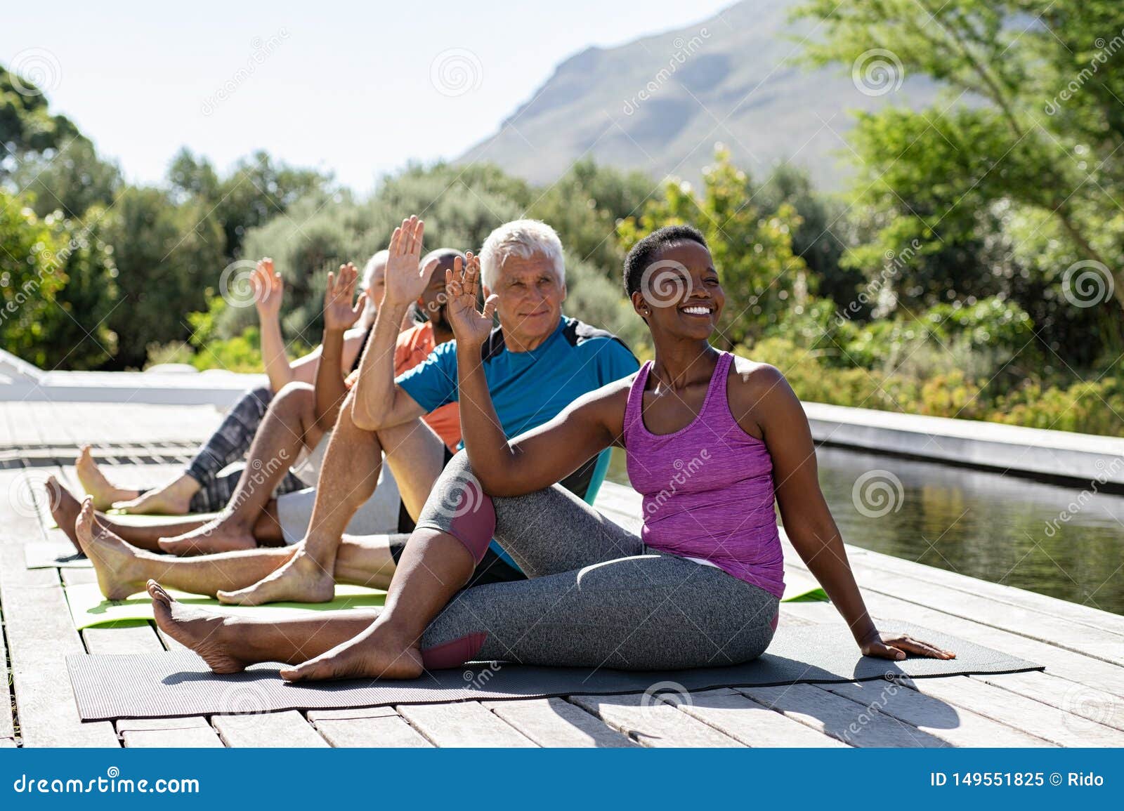 mature group of people doing yoga exercise